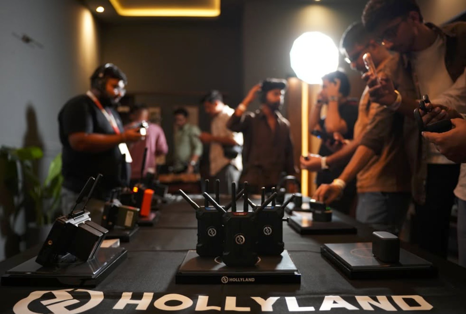 Guests trying Hollyland wireless video gear on the demo table