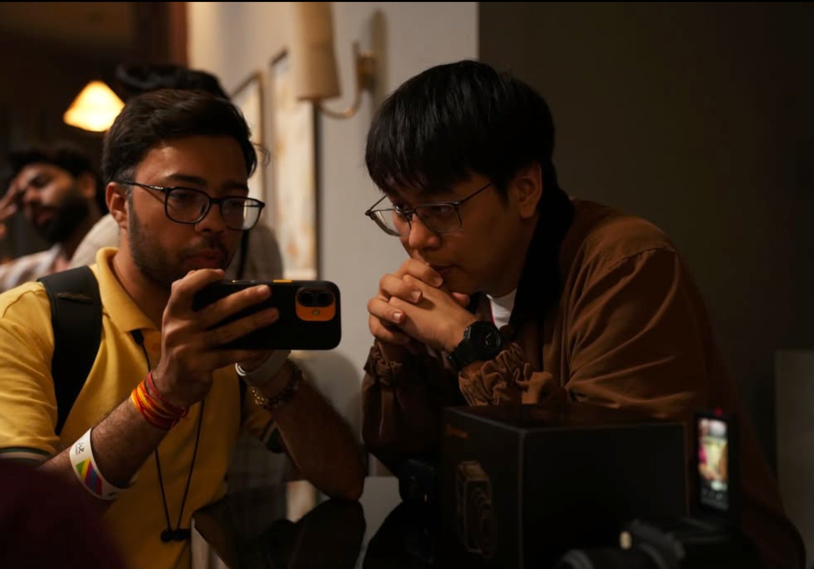 Two attendees reviewing a shot on a monitor