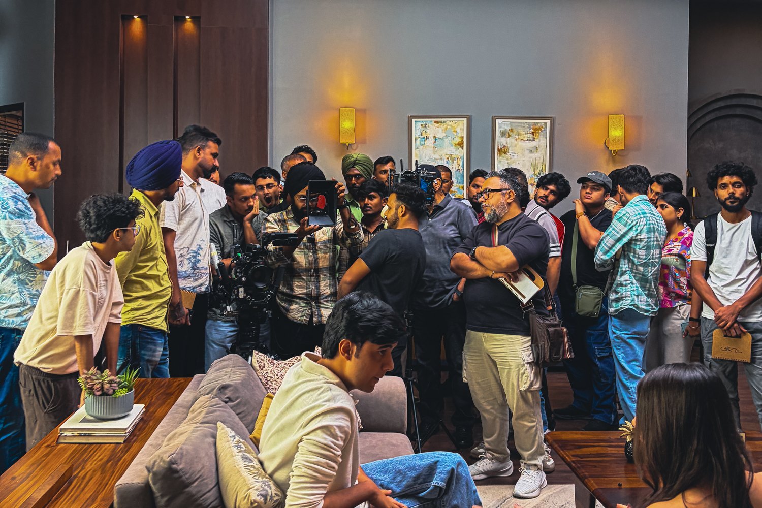 Attendees gathered around a camera setup during a masterclass on the home sets