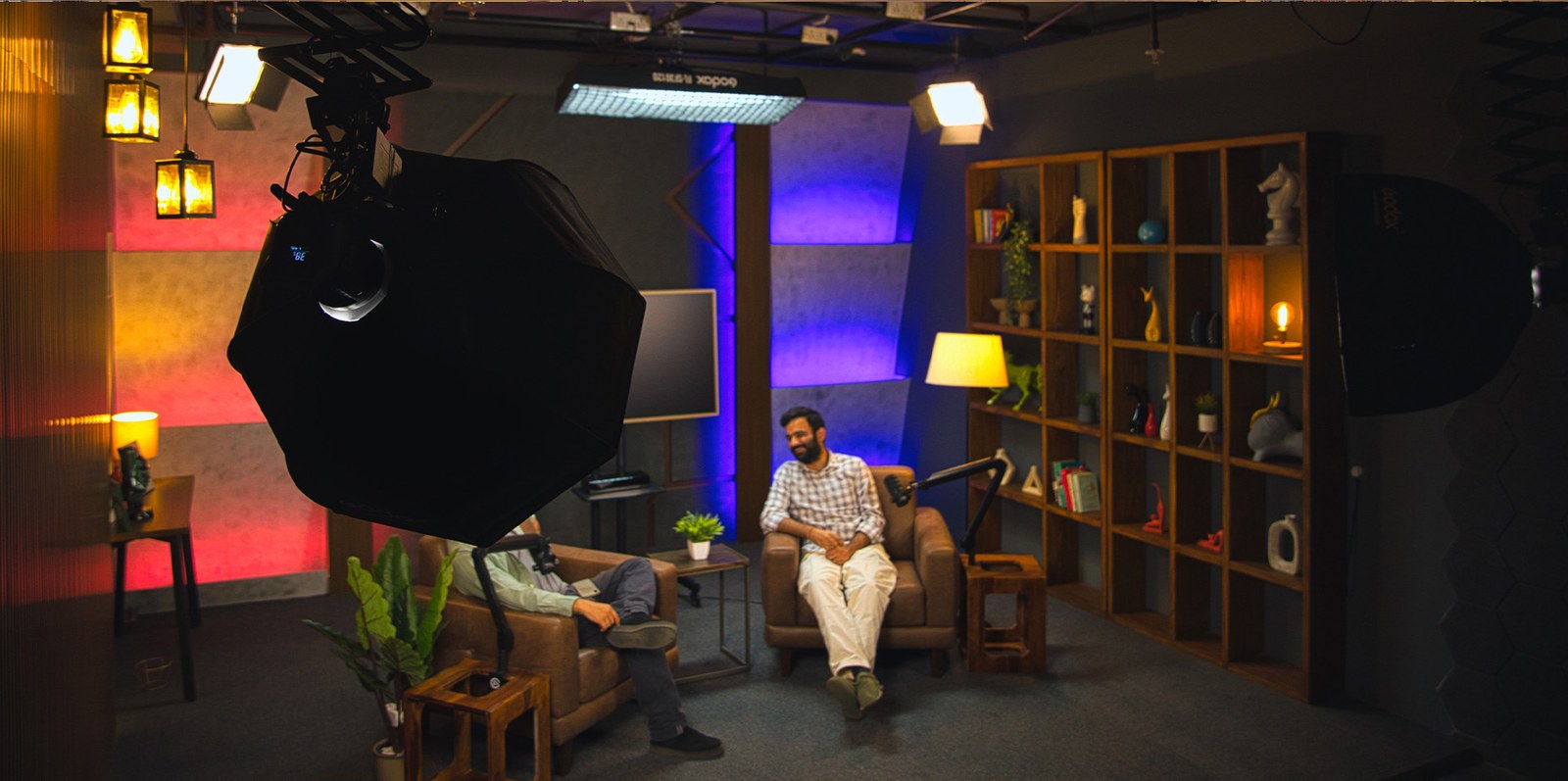 Studio One lit with RGB colour during a podcast recording
